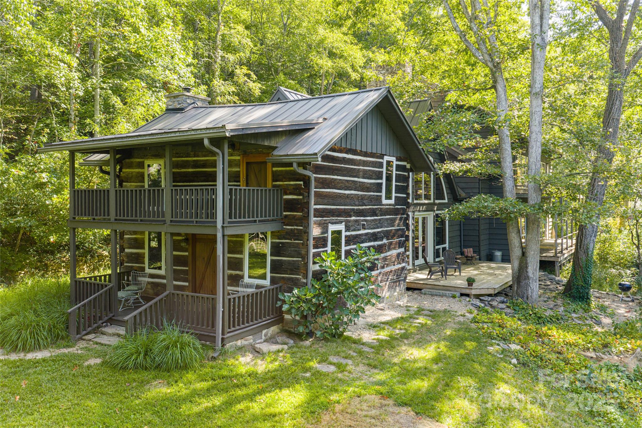 a view of house with backyard and seating area