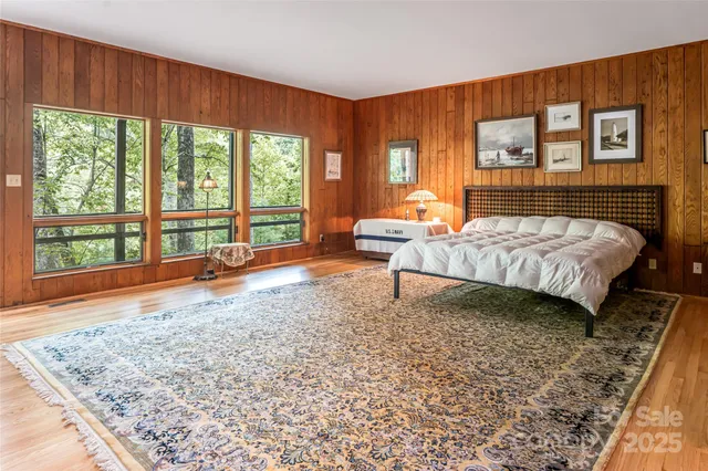 a bathroom with a granite countertop sink a toilet a mirror and shower