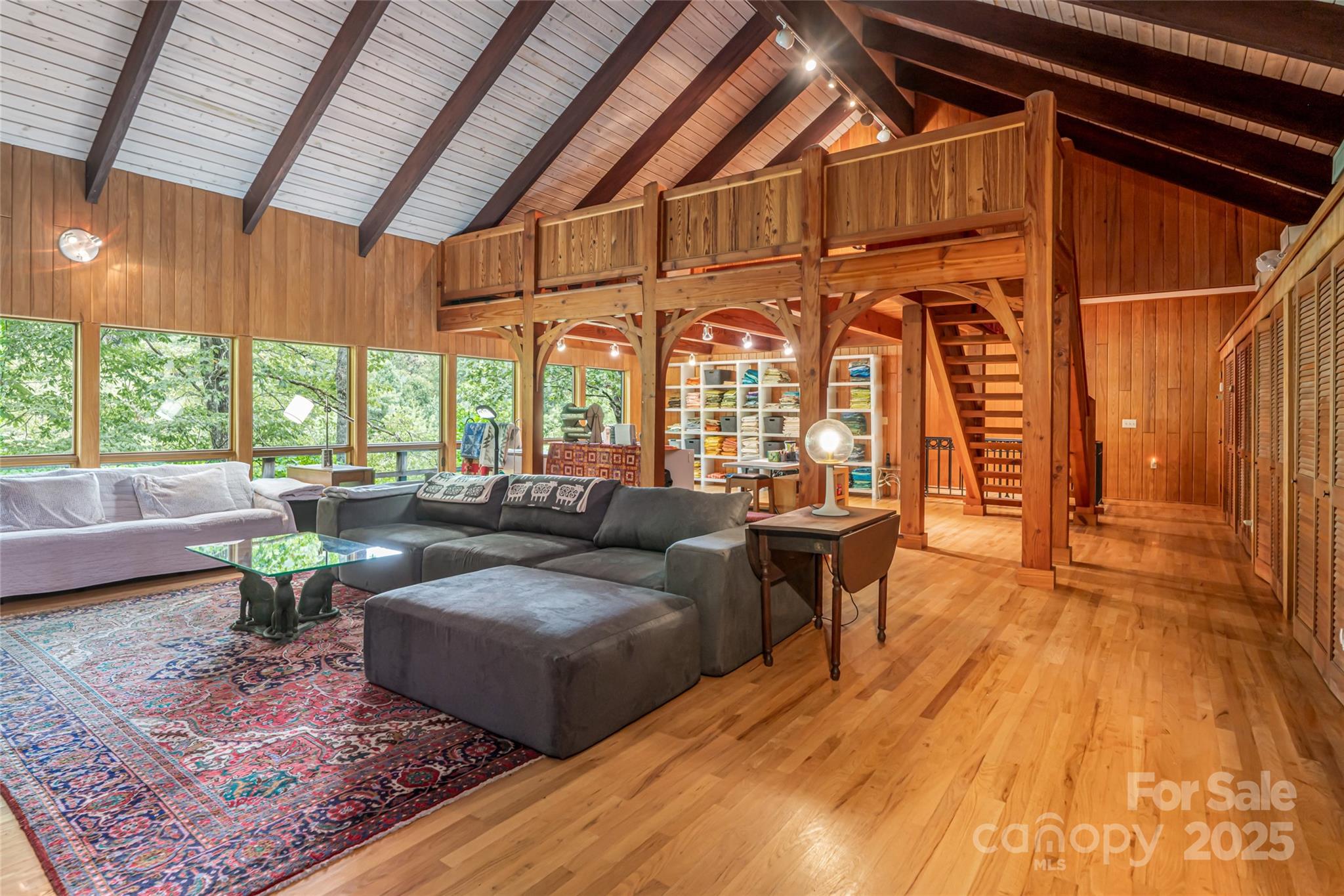 147 Dye Leaf Road Fairview, NC 28730 - Photo 25 of 46 a living room with furniture a large window and wooden floor