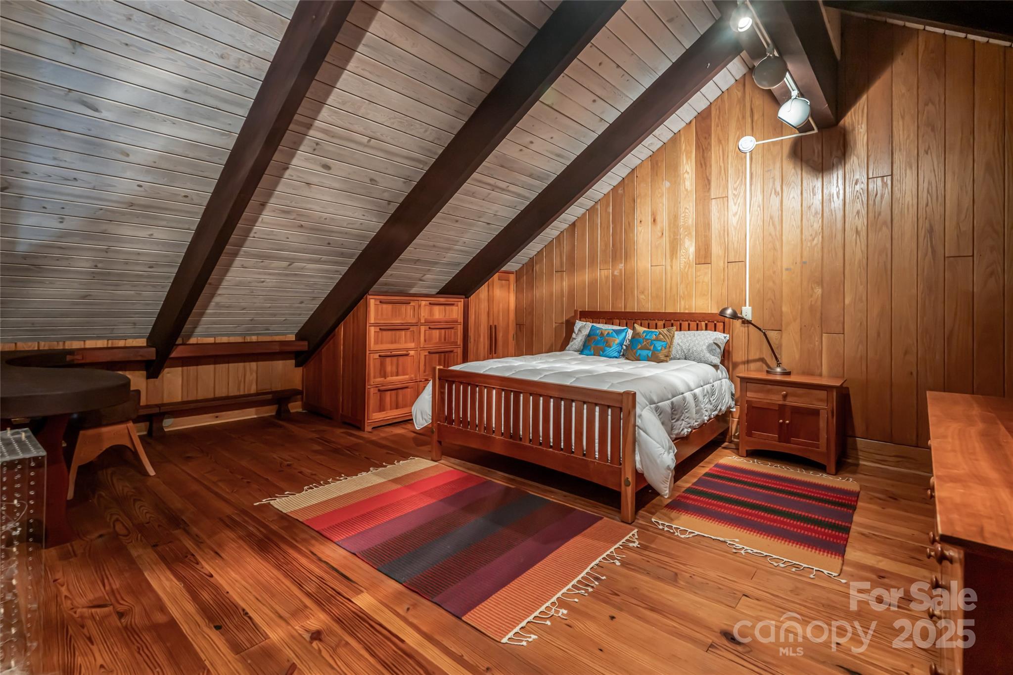 147 Dye Leaf Road Fairview, NC 28730 - Photo 27 of 46 a bedroom with furniture and wooden floor