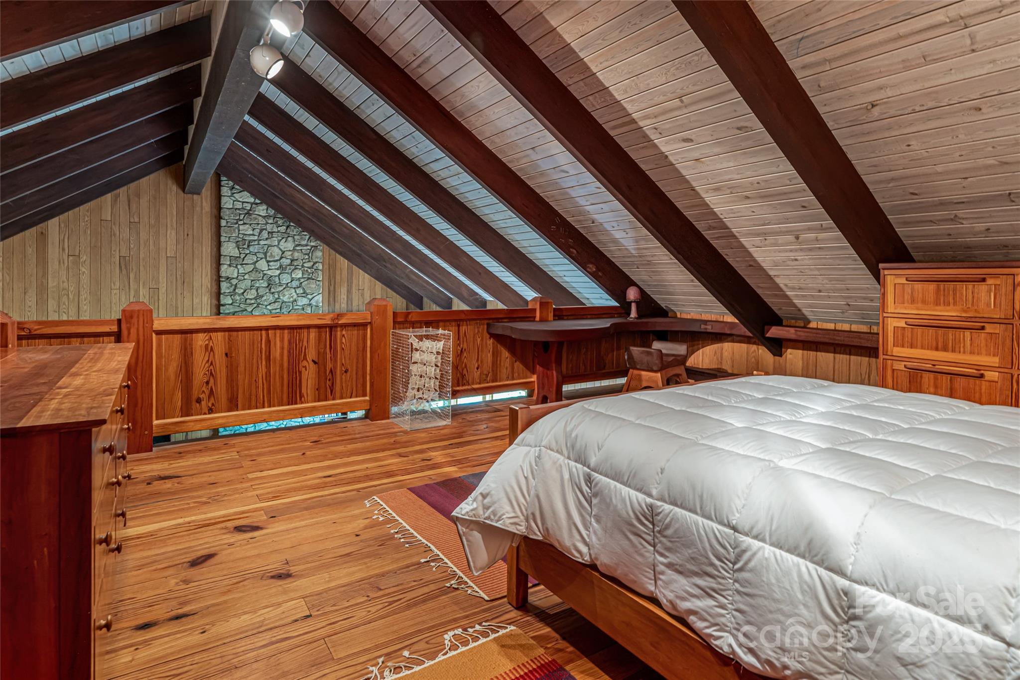 147 Dye Leaf Road Fairview, NC 28730 - Photo 28 of 46 a bedroom with a bed and wooden floors