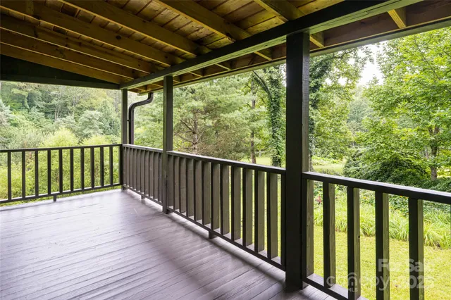 a living room with furniture a fireplace and a floor to ceiling window