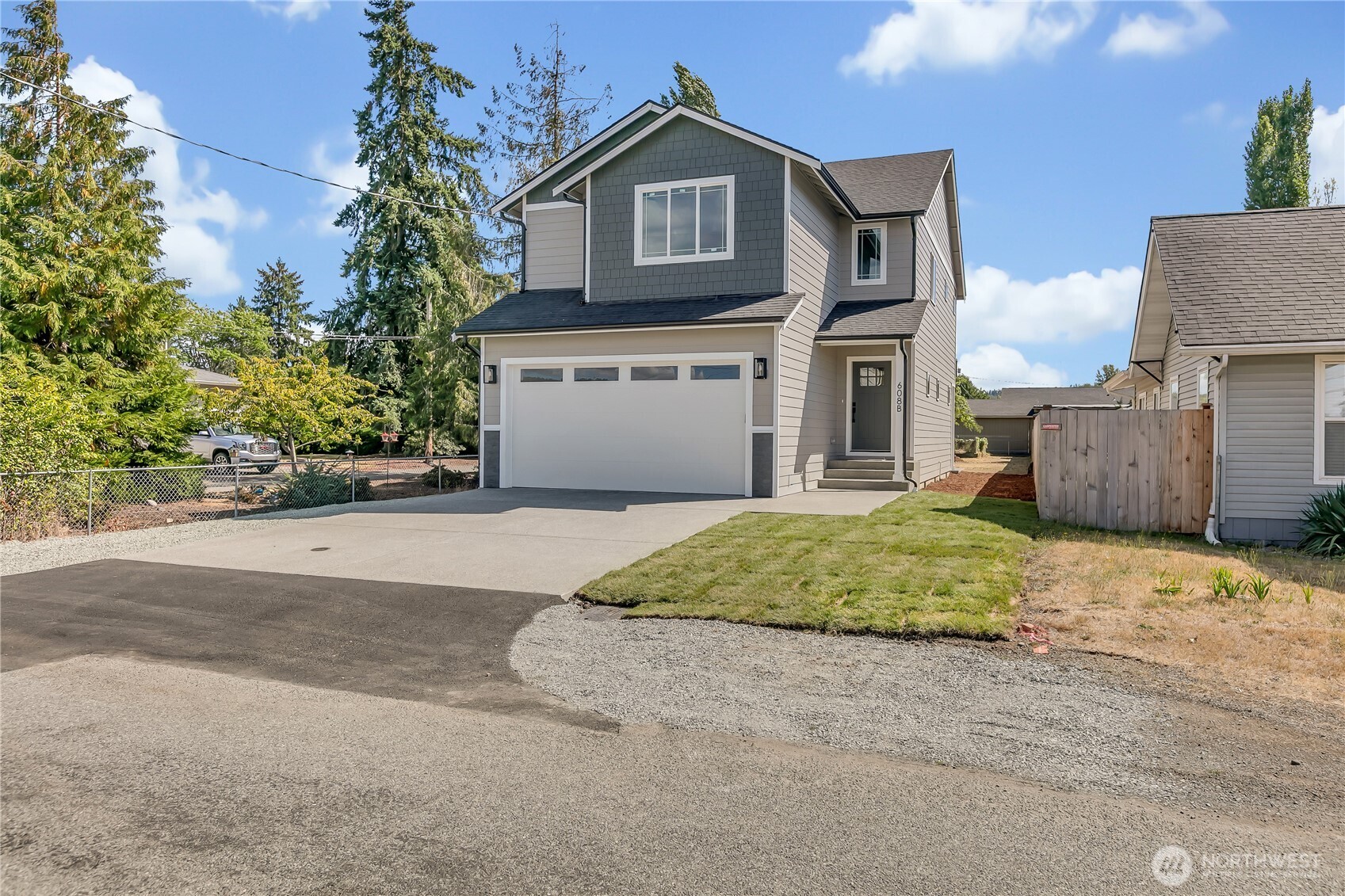 608 B Deeded Street Orting, WA 98360 - Photo 1 of 26 a front view of a house with a yard and garage