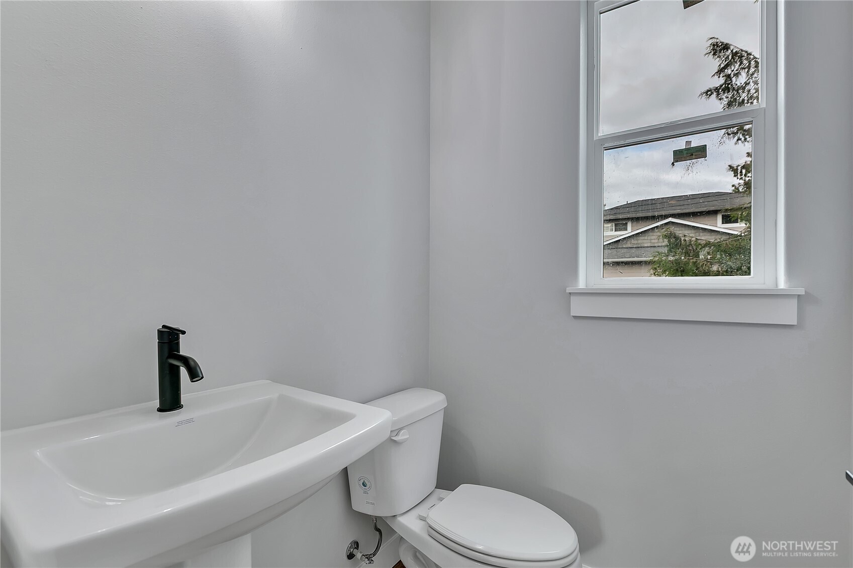 608 B Deeded Street Orting, WA 98360 - Photo 11 of 26 a white toilet sitting next to a bathroom sink