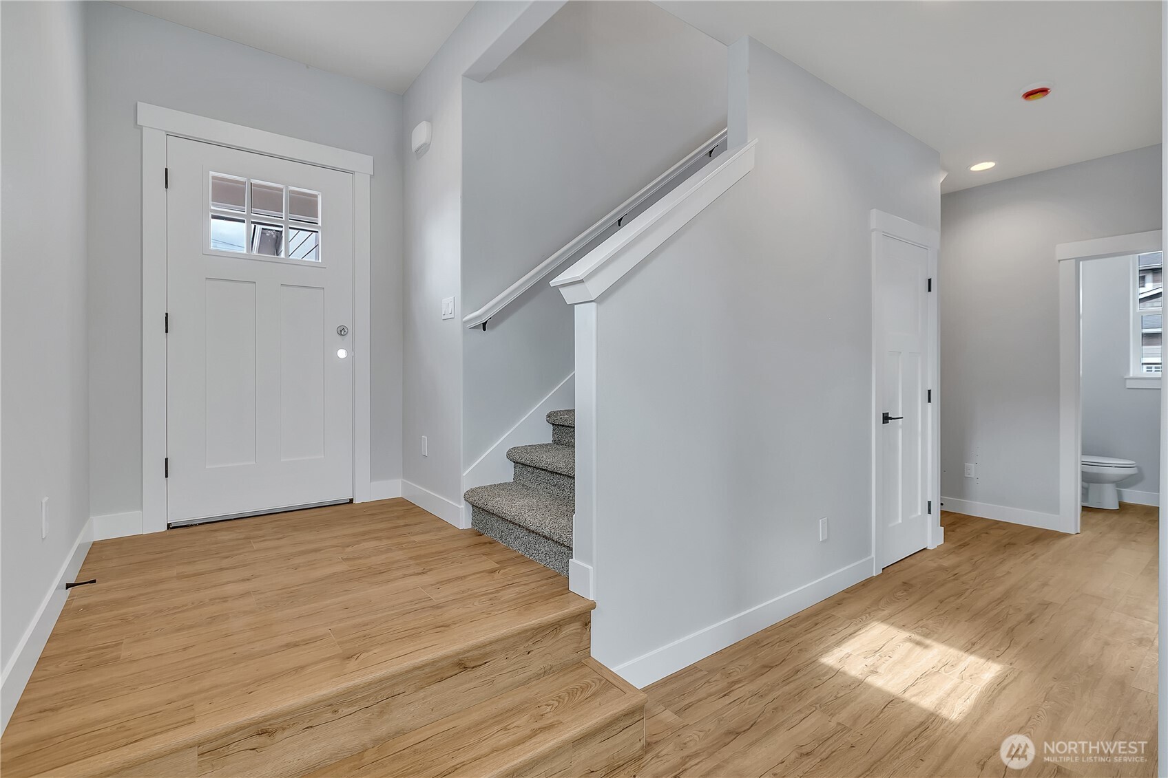 608 B Deeded Street Orting, WA 98360 - Photo 12 of 26 a view of a room with wooden floor and stairs