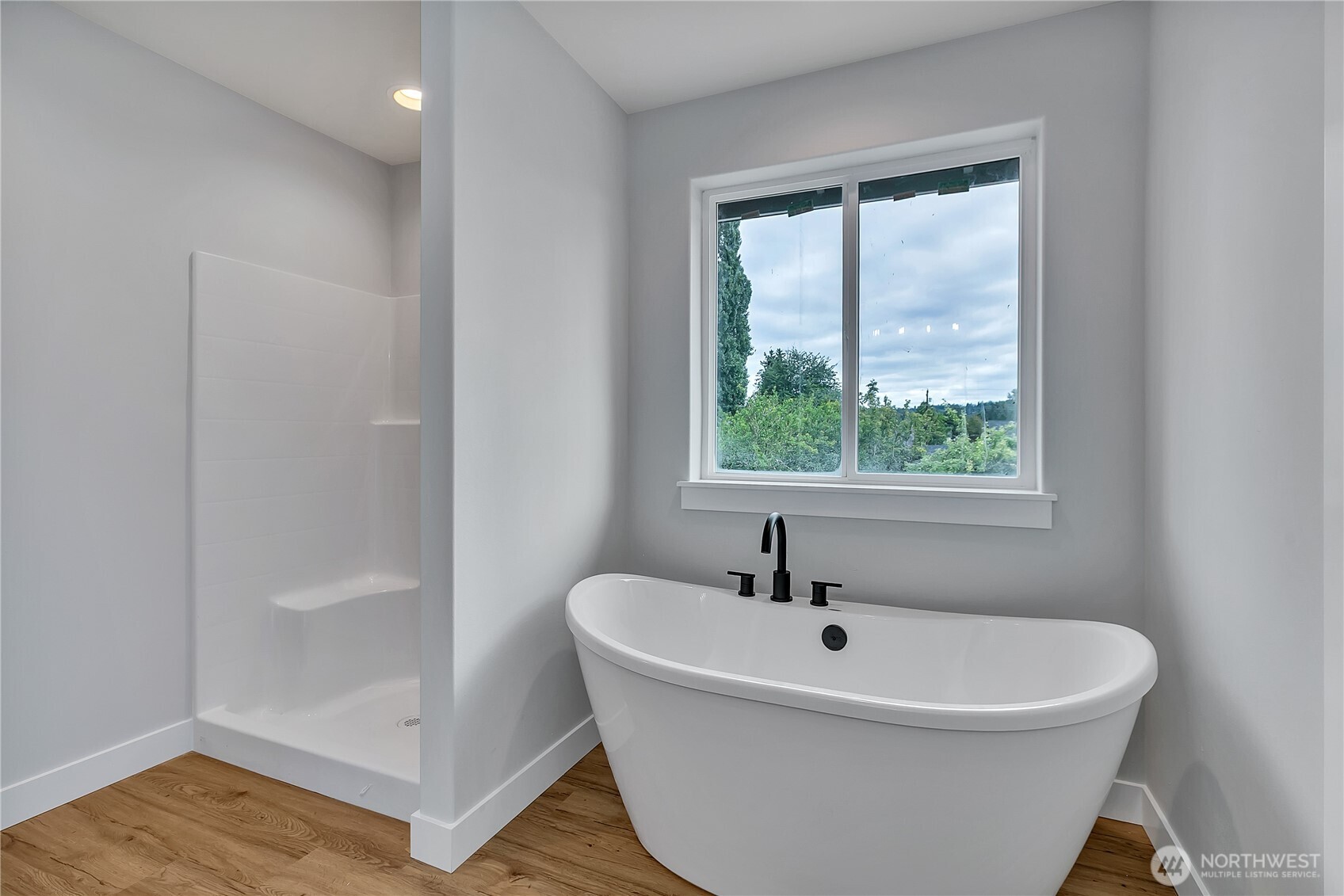 608 B Deeded Street Orting, WA 98360 - Photo 17 of 26 a white bath tub sitting in a bathroom