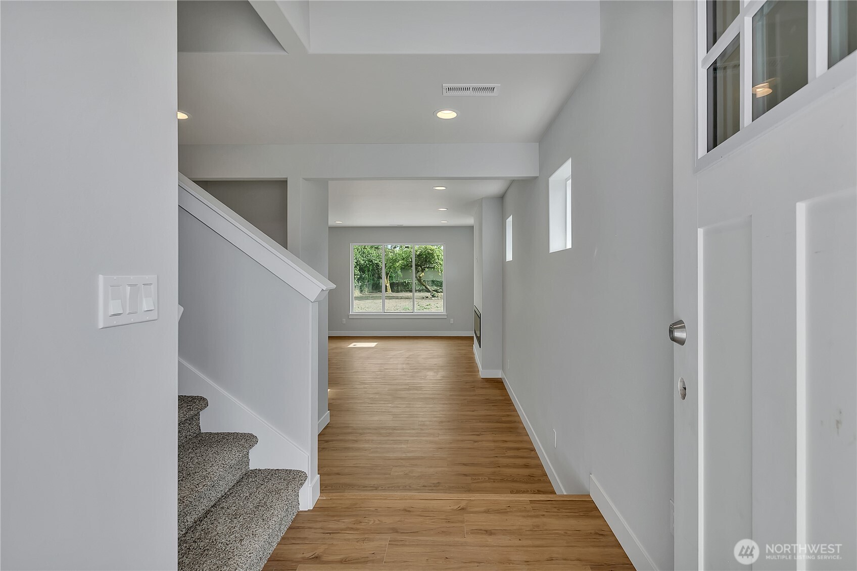 608 B Deeded Street Orting, WA 98360 - Photo 4 of 26 a view of a hallway with wooden floor and staircase