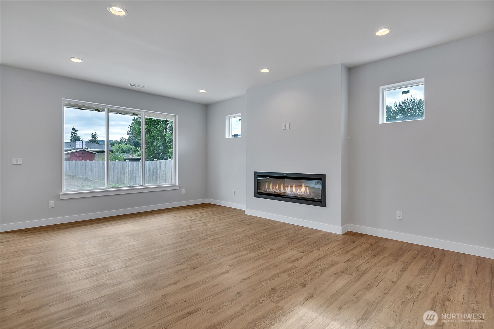 608 B Deeded Street Orting, WA 98360 - Photo 7 of 26 a view of an empty room with a window and wooden floor