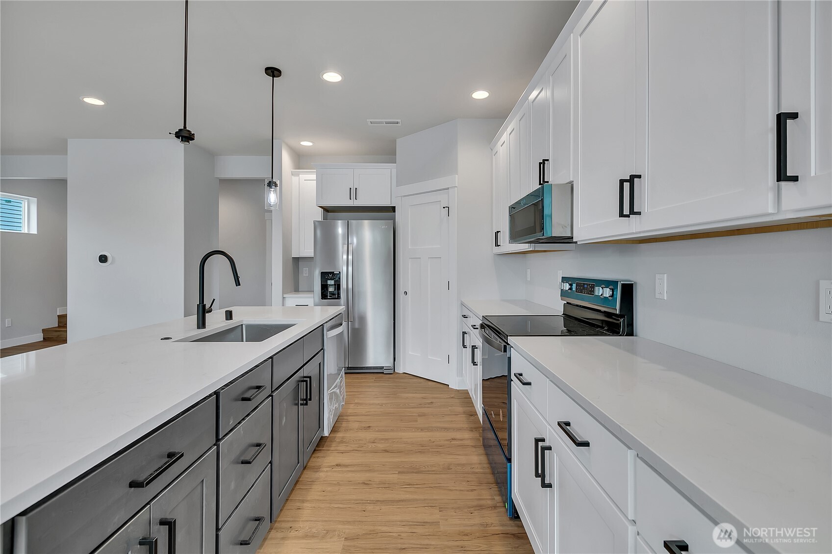 608 B Deeded Street Orting, WA 98360 - Photo 9 of 26 a kitchen with sink a refrigerator and cabinets