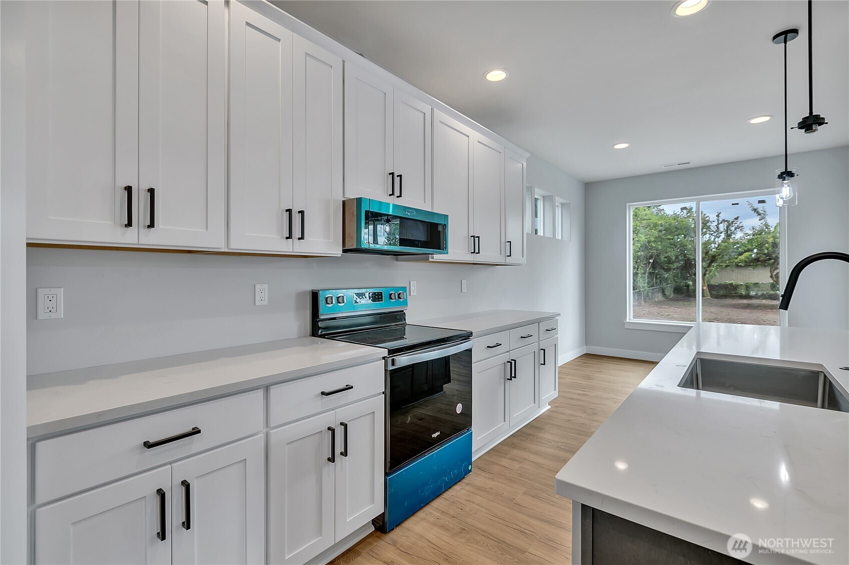 608 B Deeded Street Orting, WA 98360 - Photo 10 of 26 a kitchen with white cabinets and sink