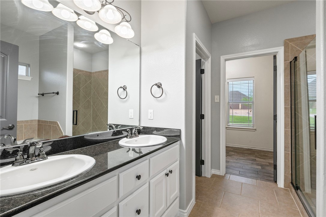 3304 Keefer Loop College Station, TX 77845 - Photo 11 of 21 a bathroom with a granite countertop sink and a mirror