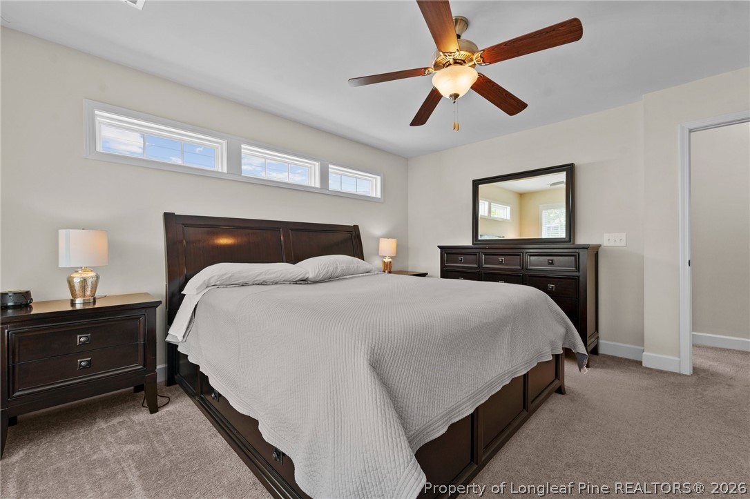 141 Pine Hawk Drive Spring Lake, NC 28390 - Photo 14 of 21 a bedroom with a bed and a chandelier