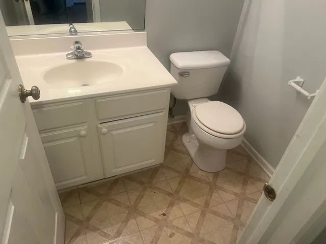a white toilet sitting next to a bathroom sink
