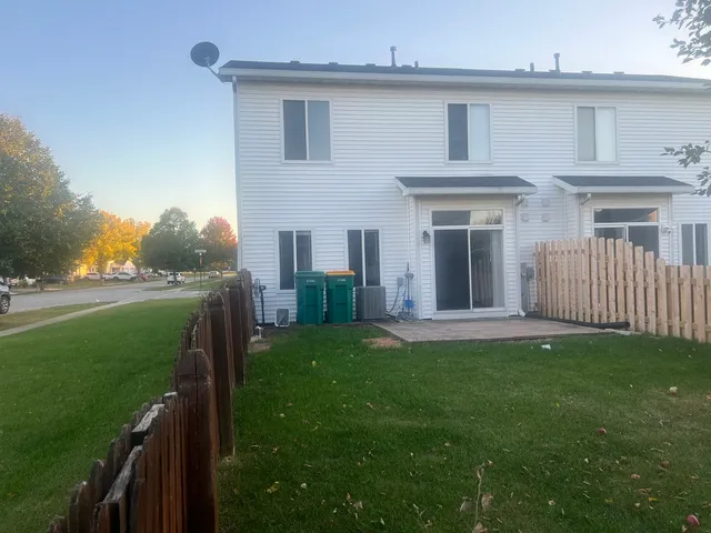 a view of a house with a yard and a porch