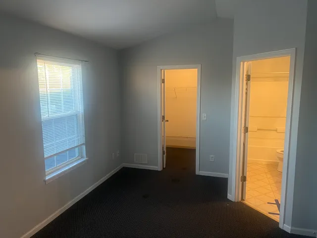 a view of an empty room and a window