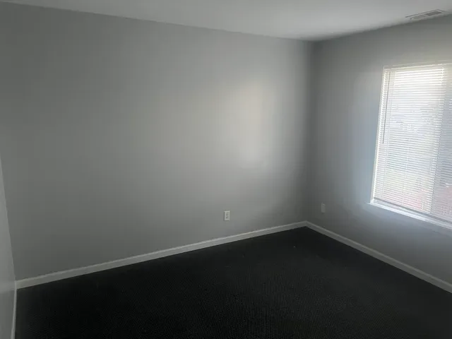 a view of a small space with wooden floor and a window