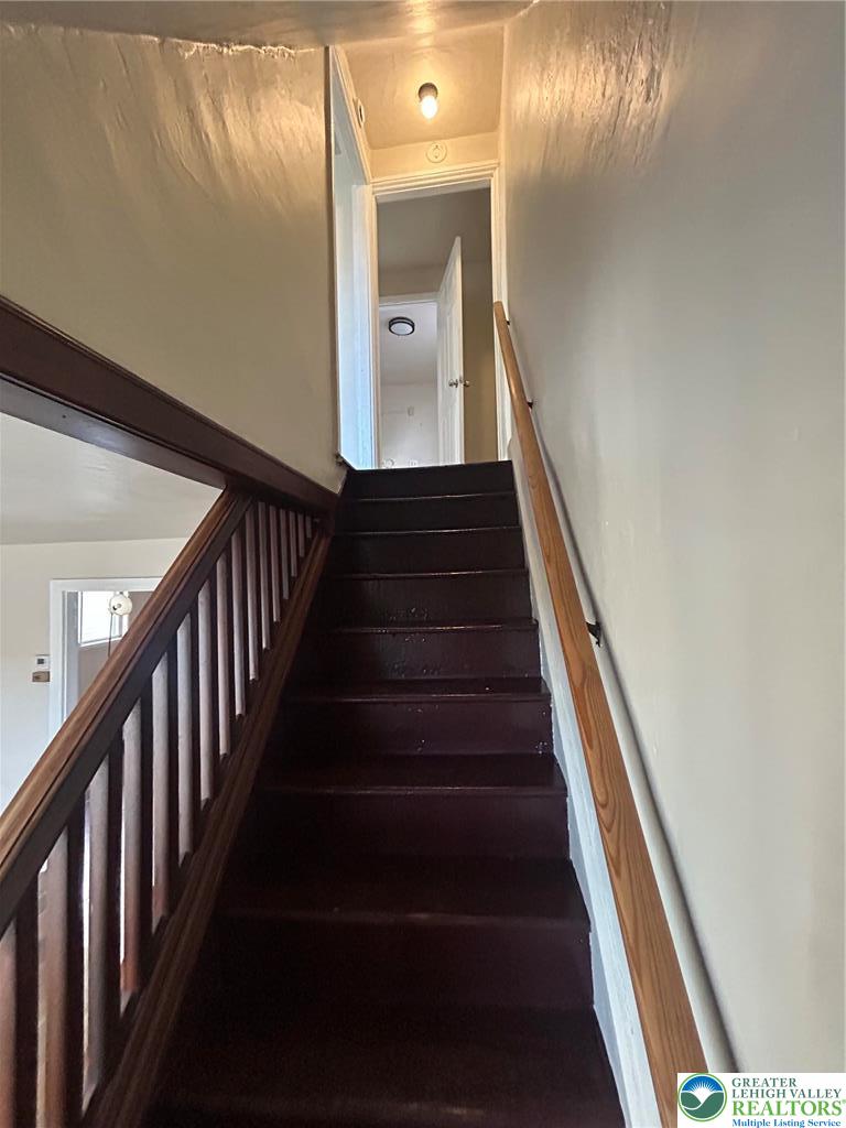1122 East 4th Street Bethlehem, PA 18015 - Photo 7 of 13 Richly stained wood steps guide the ascent, leading to sunlit upper levels.