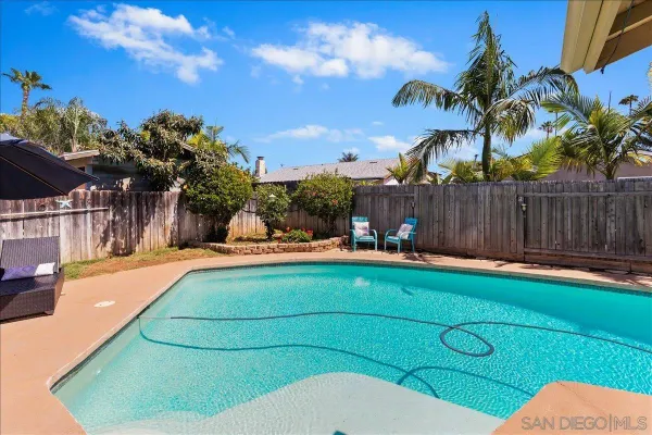 a swimming pool with outdoor seating and yard