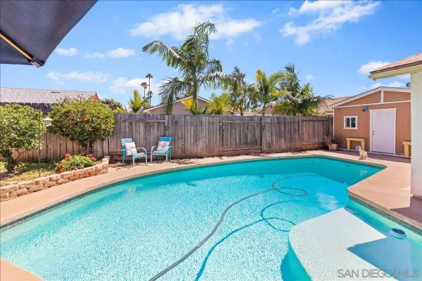 a view of a backyard with plants and a patio