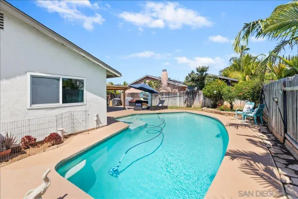 a swimming pool with outdoor seating and yard