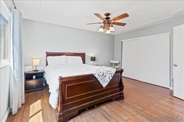 a bed room with a bed and a ceiling fan