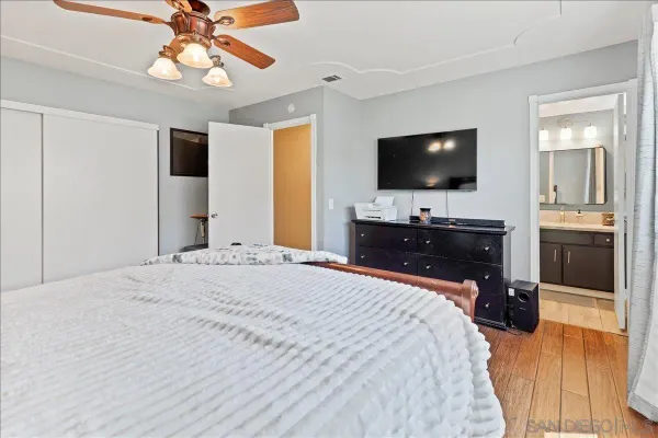 a bedroom with a bed and a flat screen tv