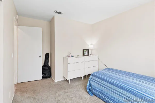 a room with a bed and a night stand