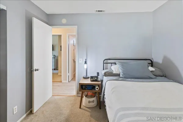 a bed room with a bed and a chair