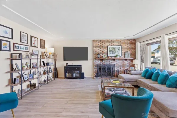 a living room with fireplace furniture and a flat screen tv