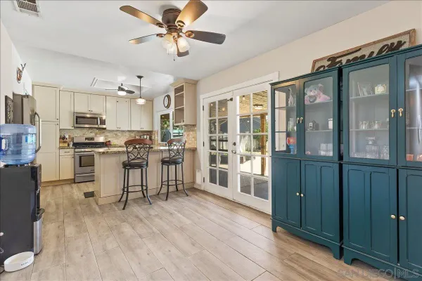a view of kitchen with center island and stainless steel appliances