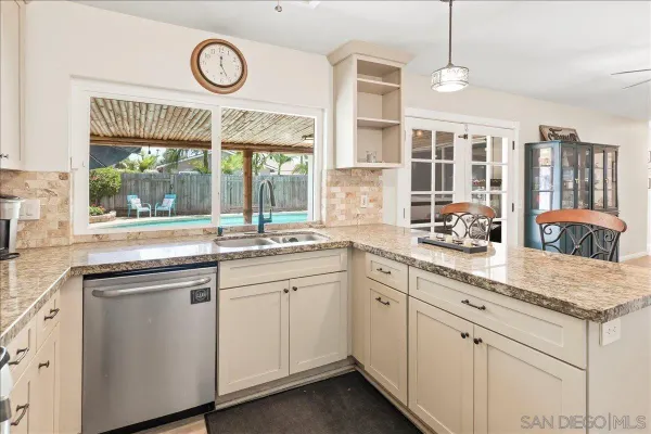 a kitchen with cabinets a sink and appliances