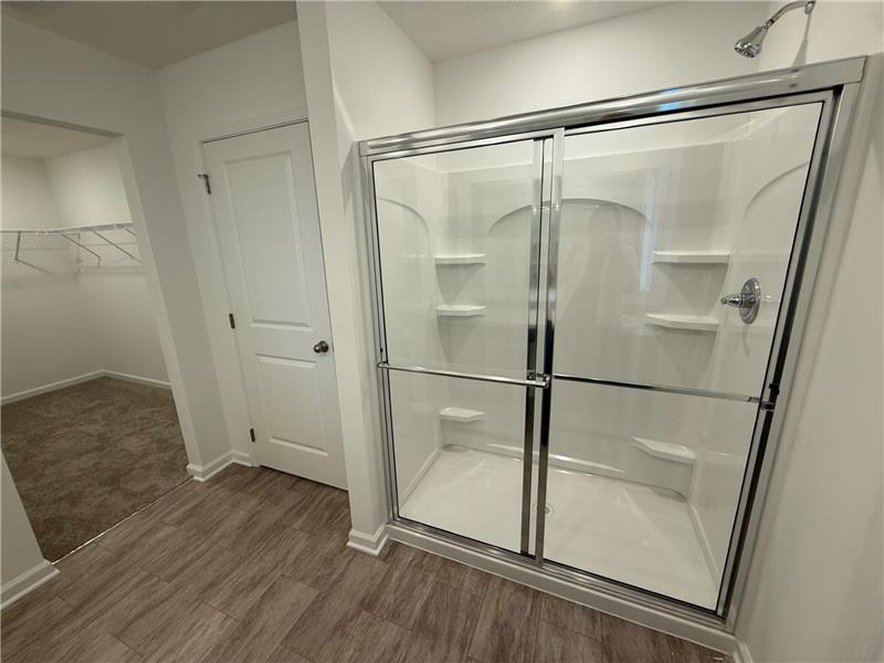 4005 Chakeres Avenue Springfield, OH 45505 - Photo 12 of 19 This primary bathroom features a shower with sliding glass doors and a spacious walk-in closet.