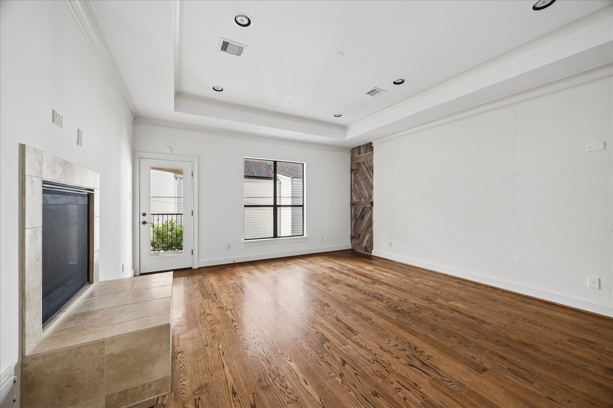 2246 Branard Street Houston, TX 77098 - Photo 24 of 40 Serene primary suite featuring generous proportions, rich hardwoods, and a thoughtfully integrated accent wall.