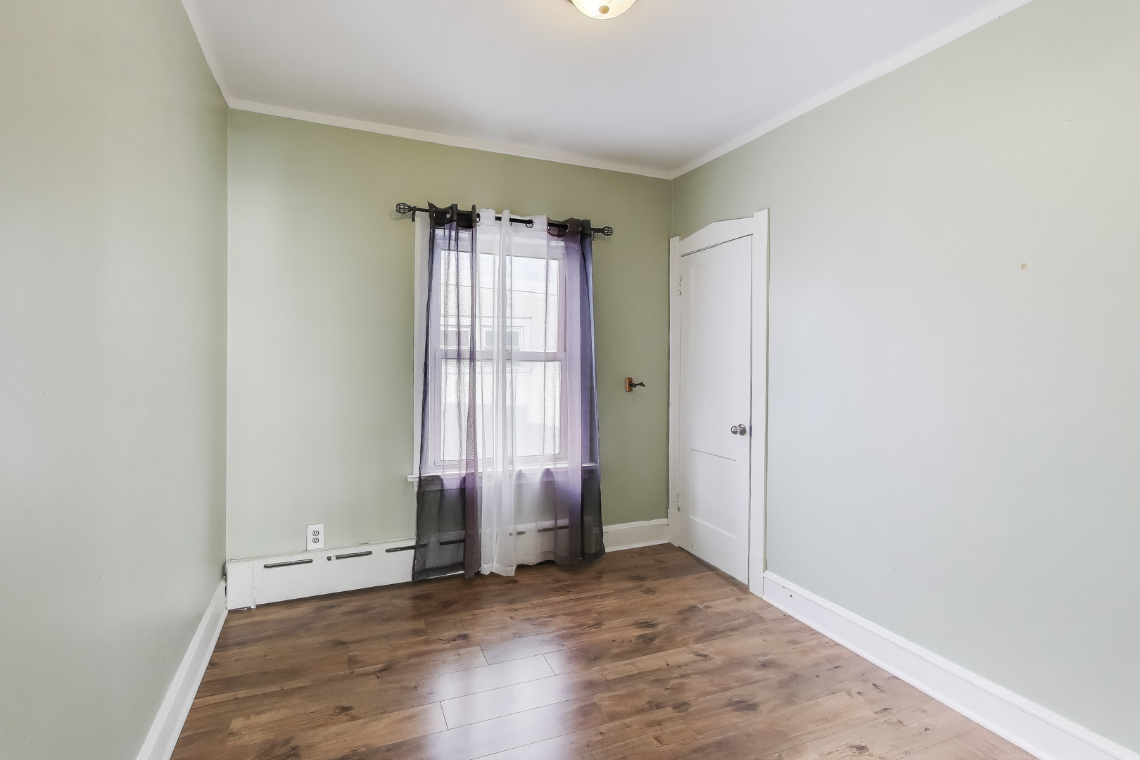 620 Elgin Avenue, Unit 2 Forest Park, IL 60130 - Photo 11 of 25 an empty room with wooden floor and windows