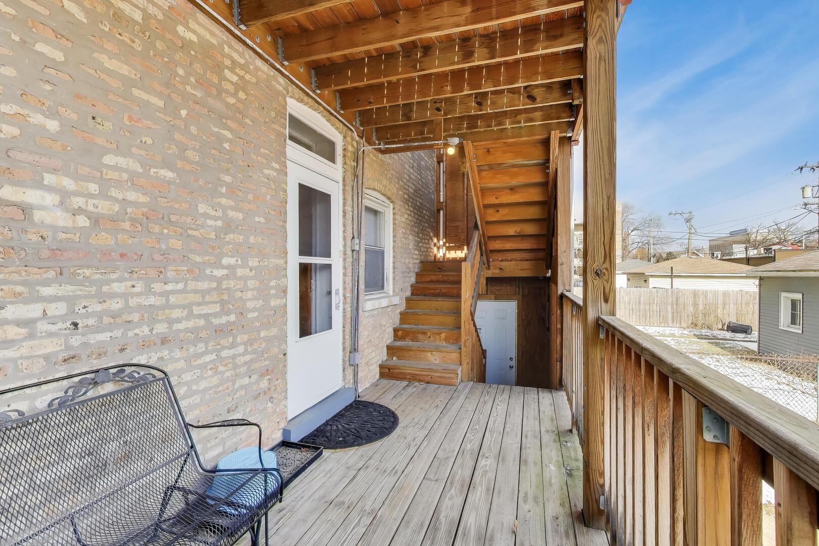 620 Elgin Avenue, Unit 2 Forest Park, IL 60130 - Photo 23 of 25 a view of a balcony with wooden floor and iron stairs