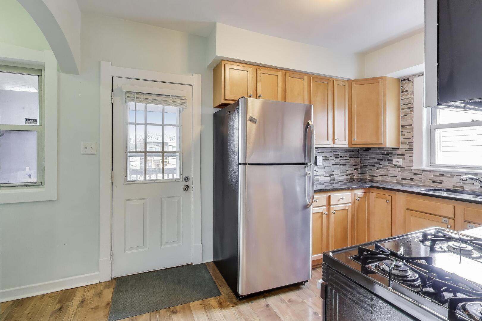620 Elgin Avenue, Unit 2 Forest Park, IL 60130 - Photo 5 of 25 a kitchen with granite countertop a refrigerator and a sink