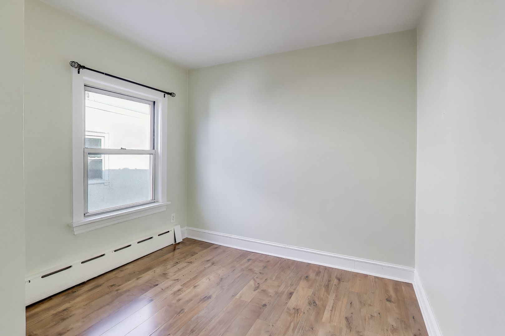 620 Elgin Avenue, Unit 2 Forest Park, IL 60130 - Photo 10 of 25 an empty room with wooden floor and windows