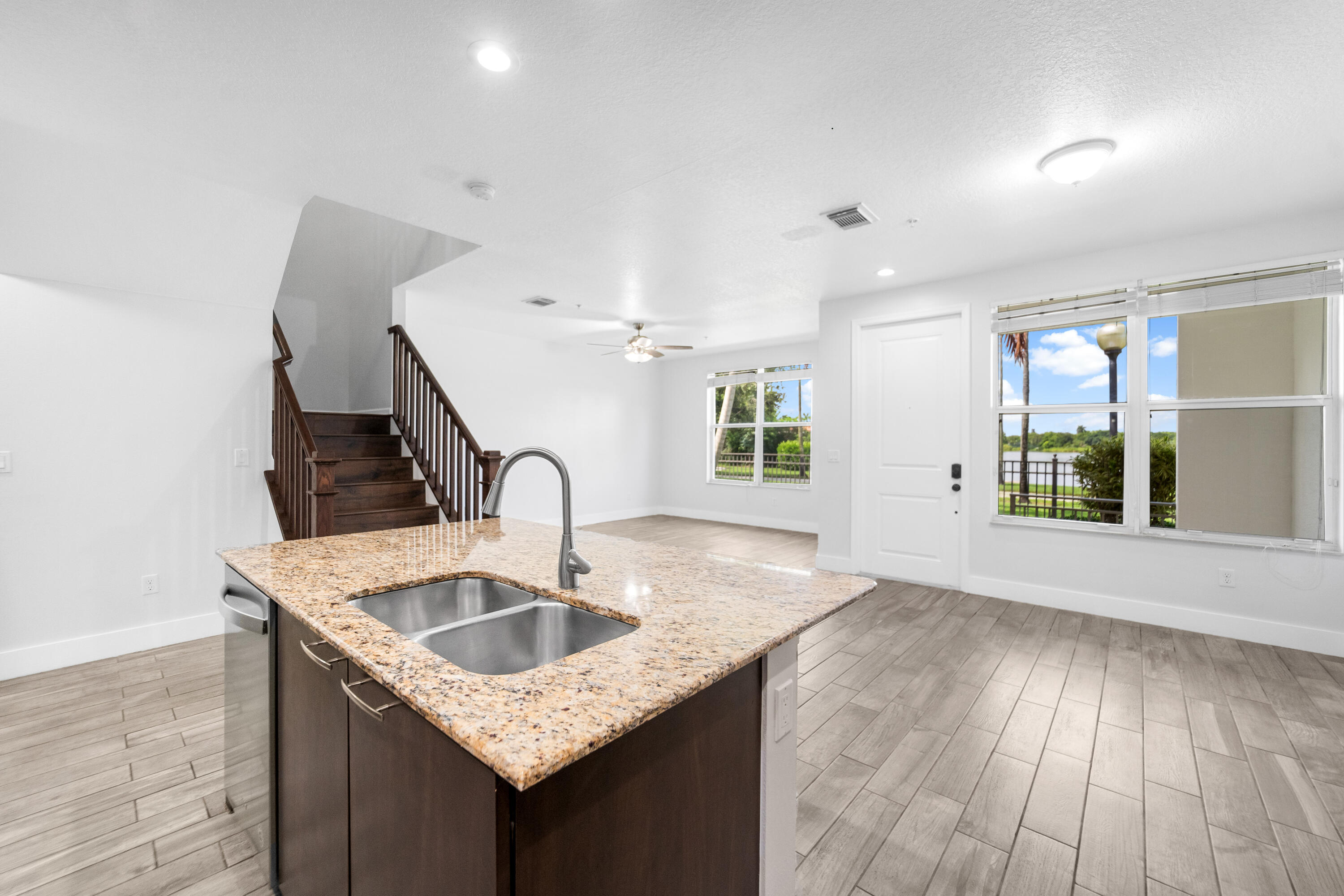 1430 Northwest 48th Lane Boca Raton, FL 33431 - Photo 13 of 54 a kitchen with granite countertop a sink a stove and wooden floor