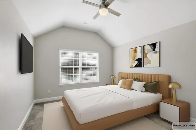 a bedroom with a large bed and a window