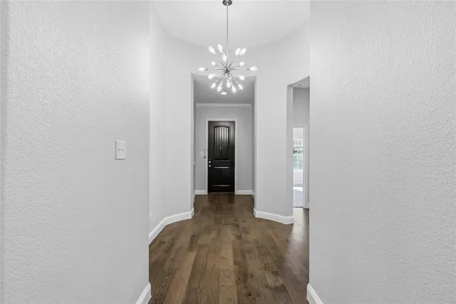 a view of a chandelier in big room and chandelier