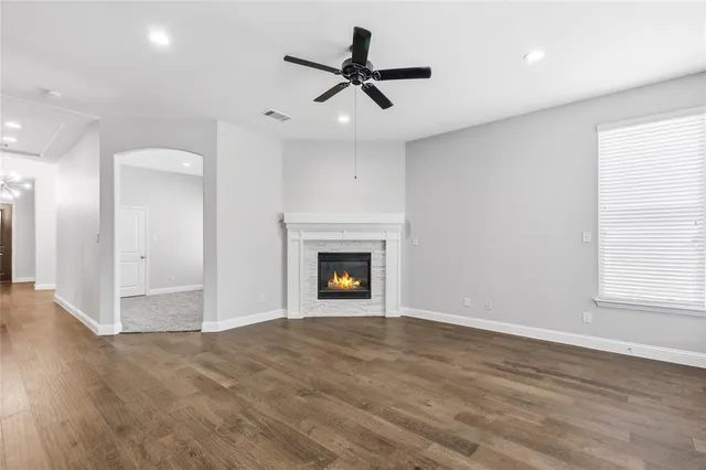 an empty room with fan and windows