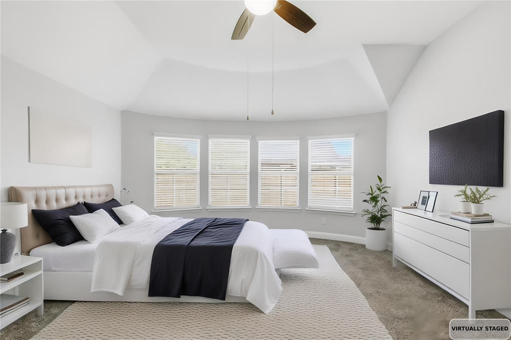 413 Allbright Road Celina, TX 75009 - Photo 5 of 37 a spacious bedroom with a bed and a flat screen tv