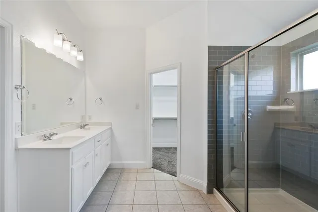 a spacious bathroom with a shower and a sink