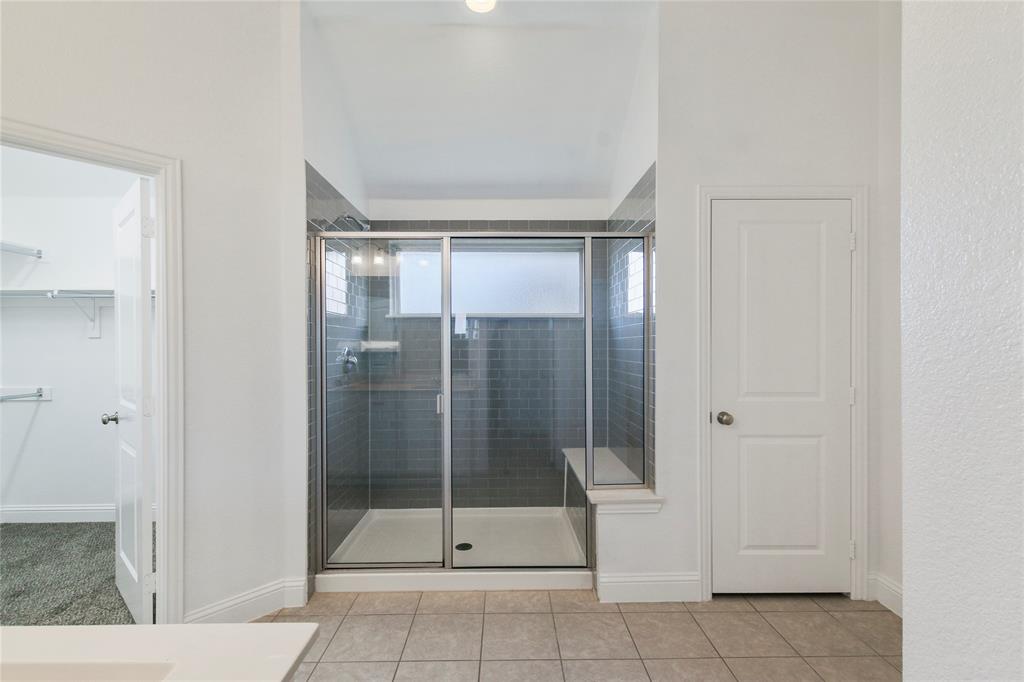 413 Allbright Road Celina, TX 75009 - Photo 9 of 37 a bathroom with a glass shower door