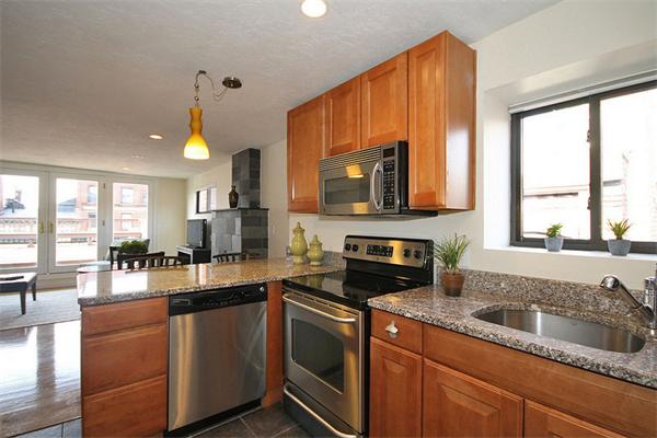 495-497 Beacon Street, Unit 10 Boston, MA 02215 - Photo 12 of 21 a kitchen with granite countertop a sink a counter top space appliances and cabinets
