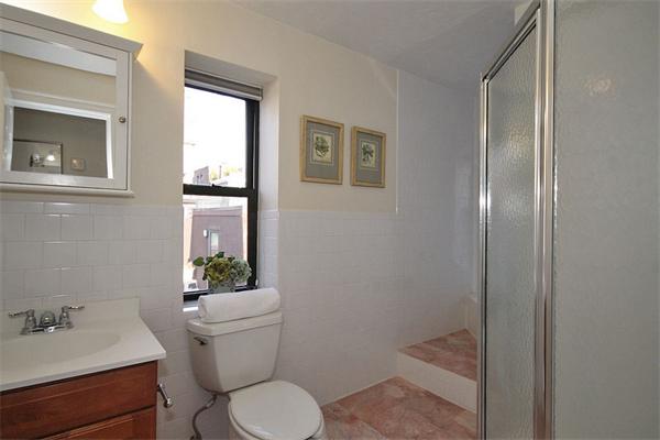 495-497 Beacon Street, Unit 10 Boston, MA 02215 - Photo 17 of 21 a white toilet sitting next to a bathroom sink