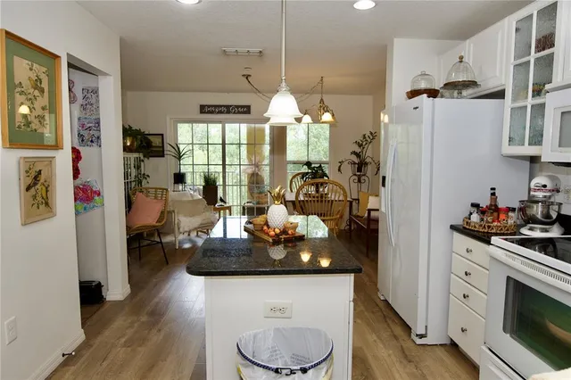 a kitchen with sink cabinets and wooden floor