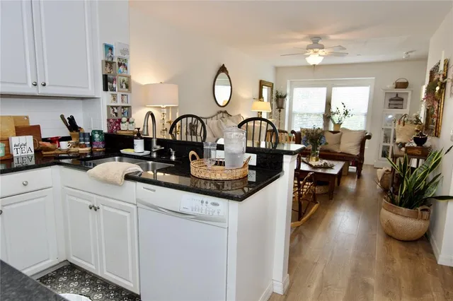 a kitchen with sink refrigerator and cabinets