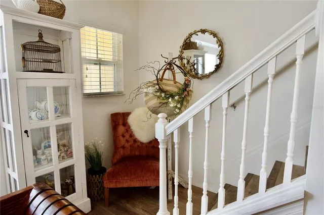 a view of a hallway with wooden floor and entryway