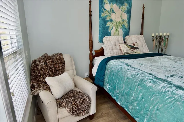 a bed sitting in a bedroom next to a window